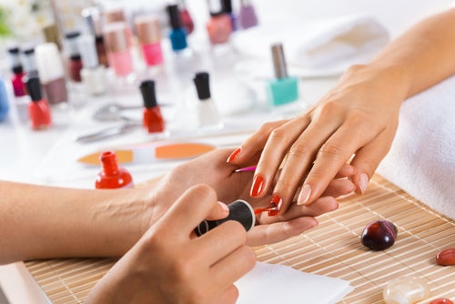 Woman in salon receiving manicure by nail beautician | Priority Honda Hampton in Hampton VA
