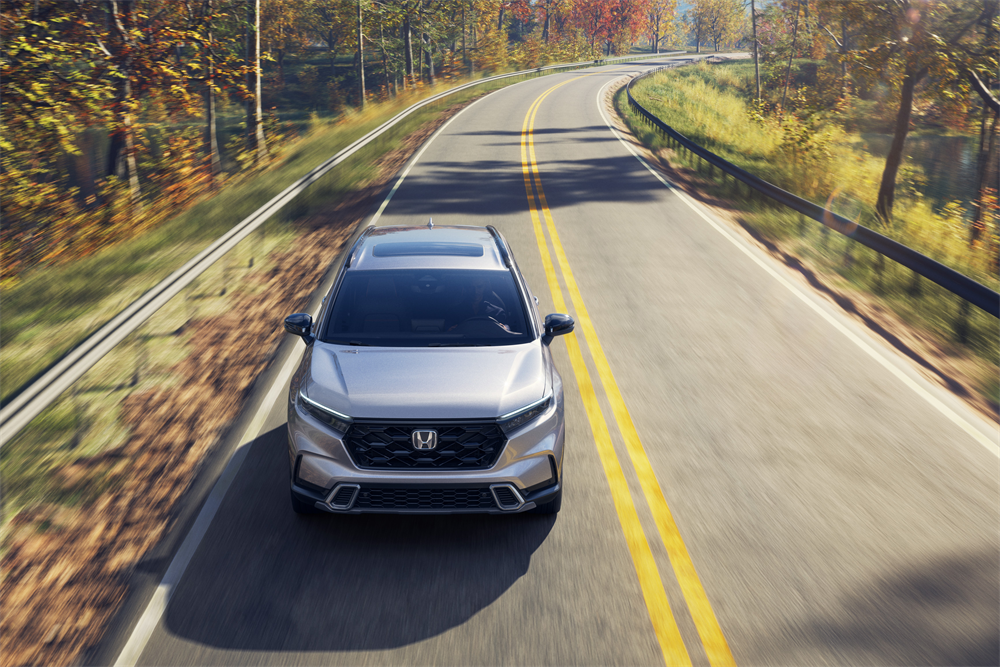 A vehicle equipped with Honda safety features on the road