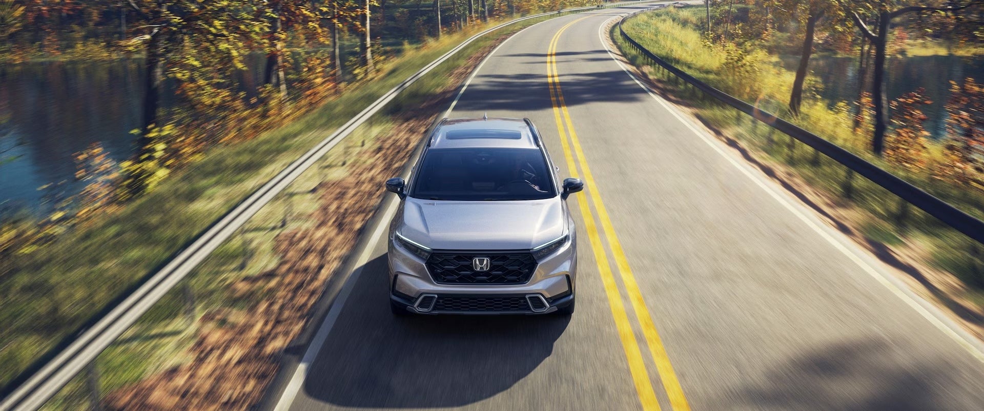 The 2026 Honda CR-V Hybrid Driving on the road